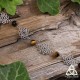 Bracelet poétique et zen orné de délicates Fleur de Vie argentée et ajourées entourées de perles en Oeil de Tigre bun.