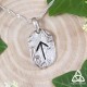 Collier artisanal Mirddin Rune Tiwaz en argent 925 - vue de face sur fond bois, style viking et médiéval fantasy